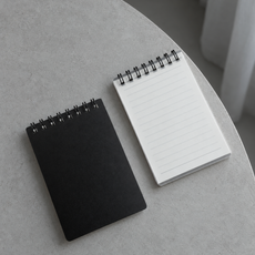 Black and transparent Business Notepads on a cool grey table