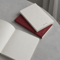 Red and ivory Note For notebooks with grid pages in cool natural light